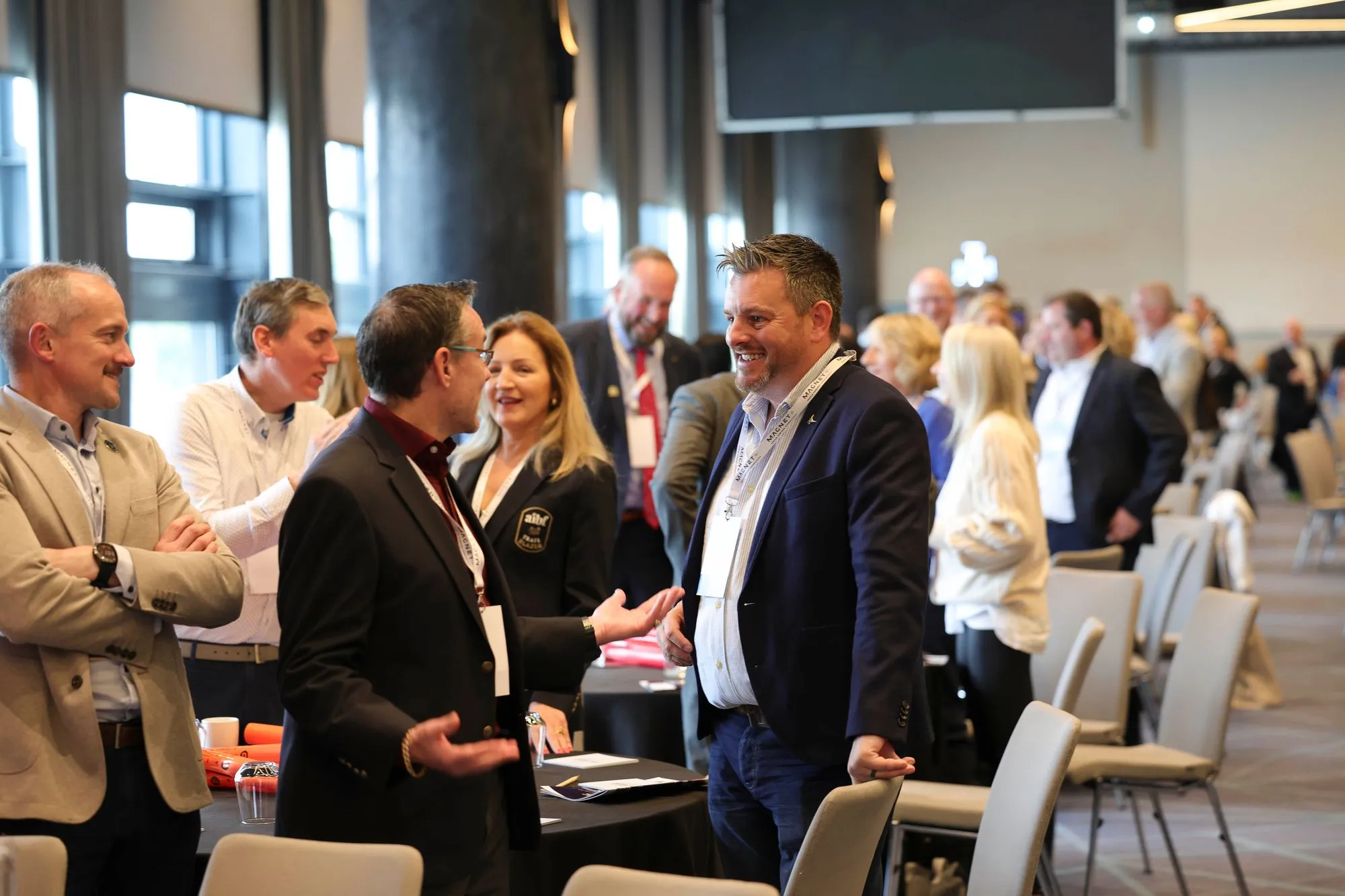 Shay Lynch talking with leaders at a networking event